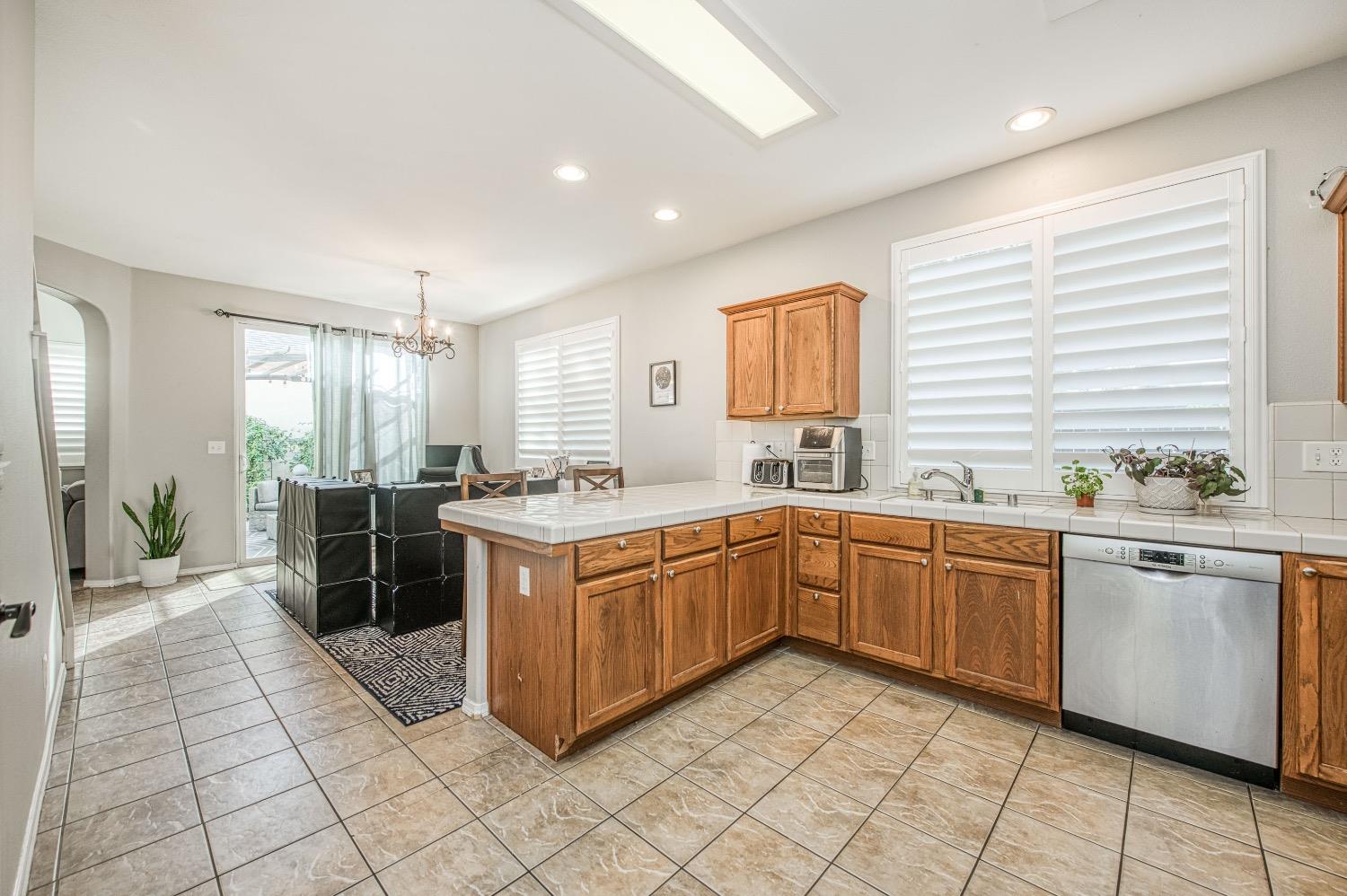 1648 North Avignon Lane Clovis, CA 93619 - Photo 12 of 27 a kitchen with stainless steel appliances granite countertop a sink and a stove