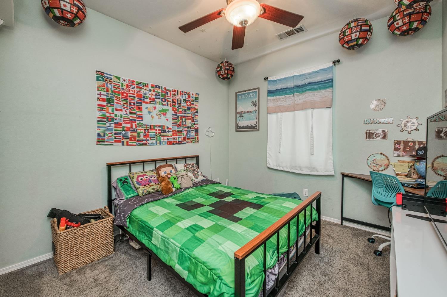 1648 North Avignon Lane Clovis, CA 93619 - Photo 14 of 27 a bedroom with bed and a chandelier