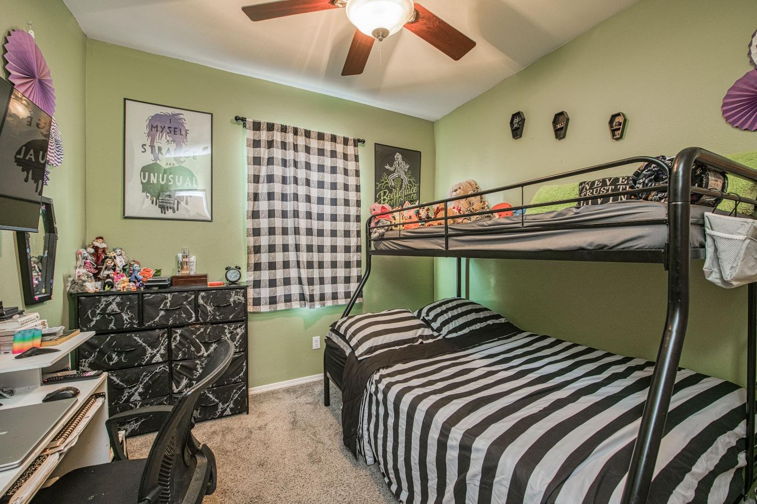 1648 North Avignon Lane Clovis, CA 93619 - Photo 17 of 27 a bedroom with a bed and a chandelier