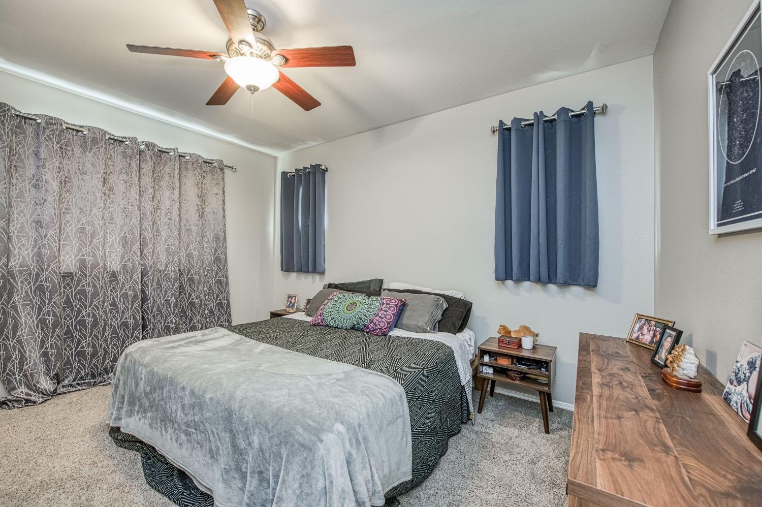 1648 North Avignon Lane Clovis, CA 93619 - Photo 20 of 27 a bedroom with a bed and a chandelier