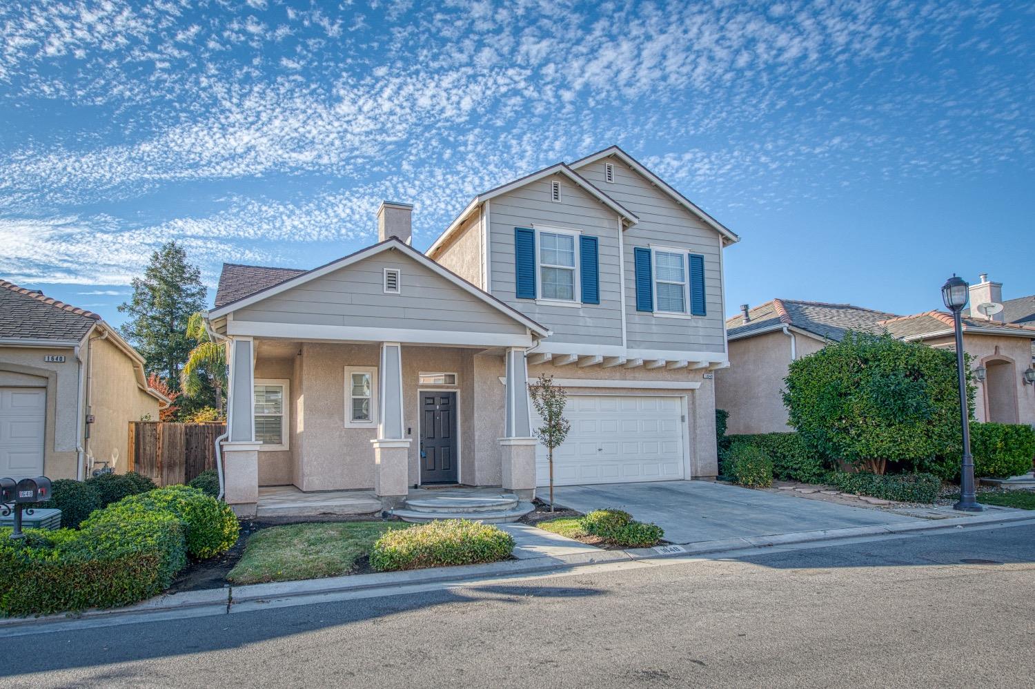 1648 North Avignon Lane Clovis, CA 93619 - Photo 2 of 27 a front view of a house with a yard and garage