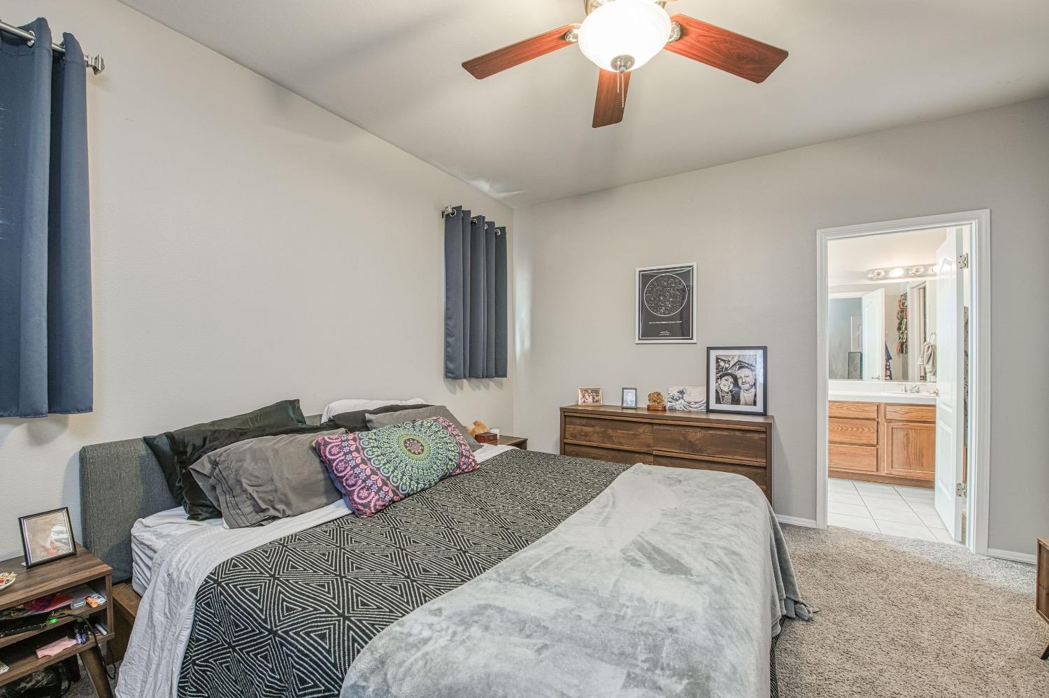 1648 North Avignon Lane Clovis, CA 93619 - Photo 21 of 27 a bedroom with a bed and a dresser