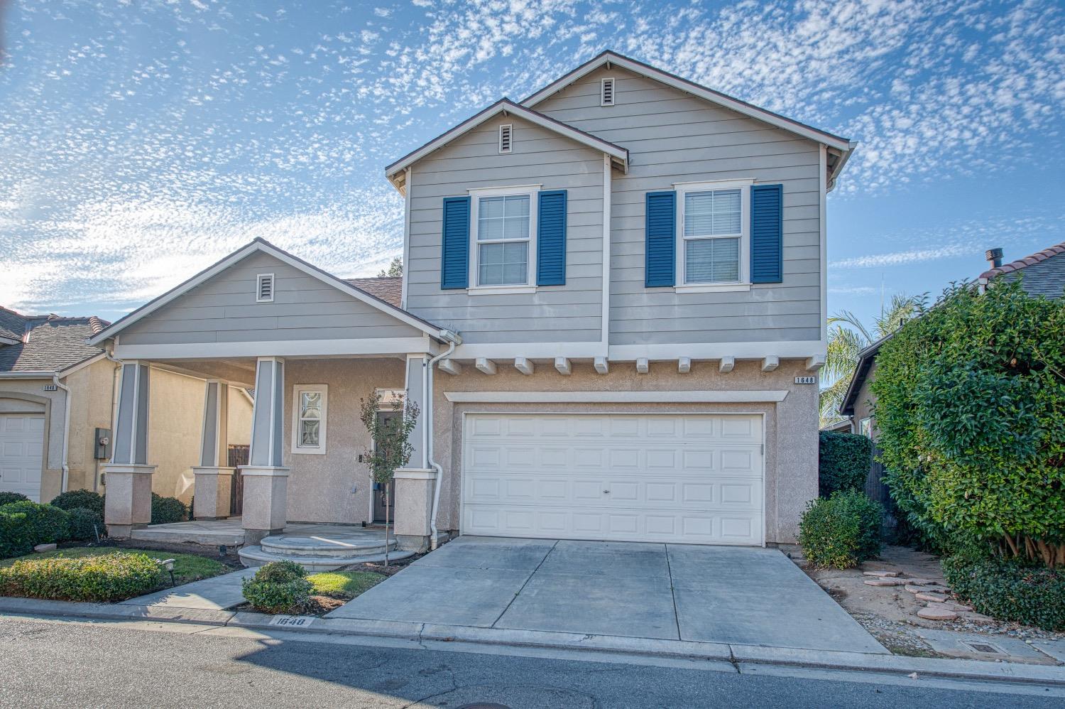 1648 North Avignon Lane Clovis, CA 93619 - Photo 3 of 27 a front view of a house with garden