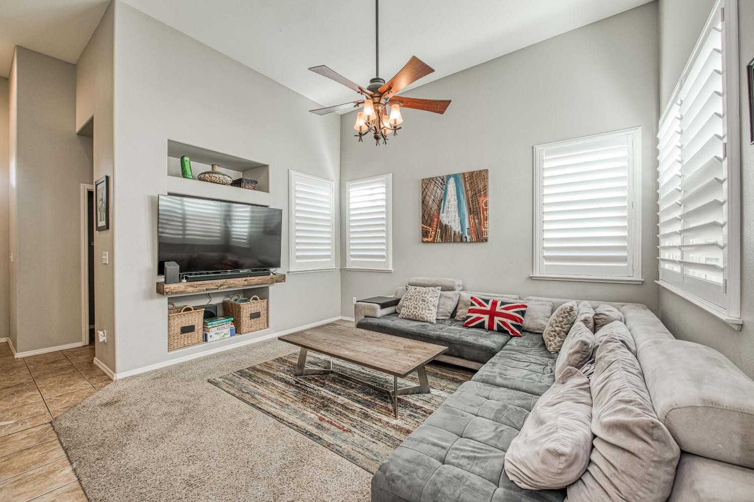 1648 North Avignon Lane Clovis, CA 93619 - Photo 5 of 27 a bedroom with a bed and a flat screen tv