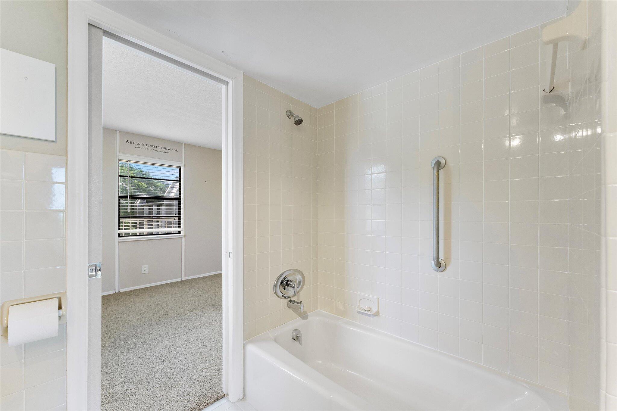 501 Southwest 11th Place, Unit 418 Boca Raton, FL 33432 - Photo 21 of 35 a bathroom with a bathtub and a shower