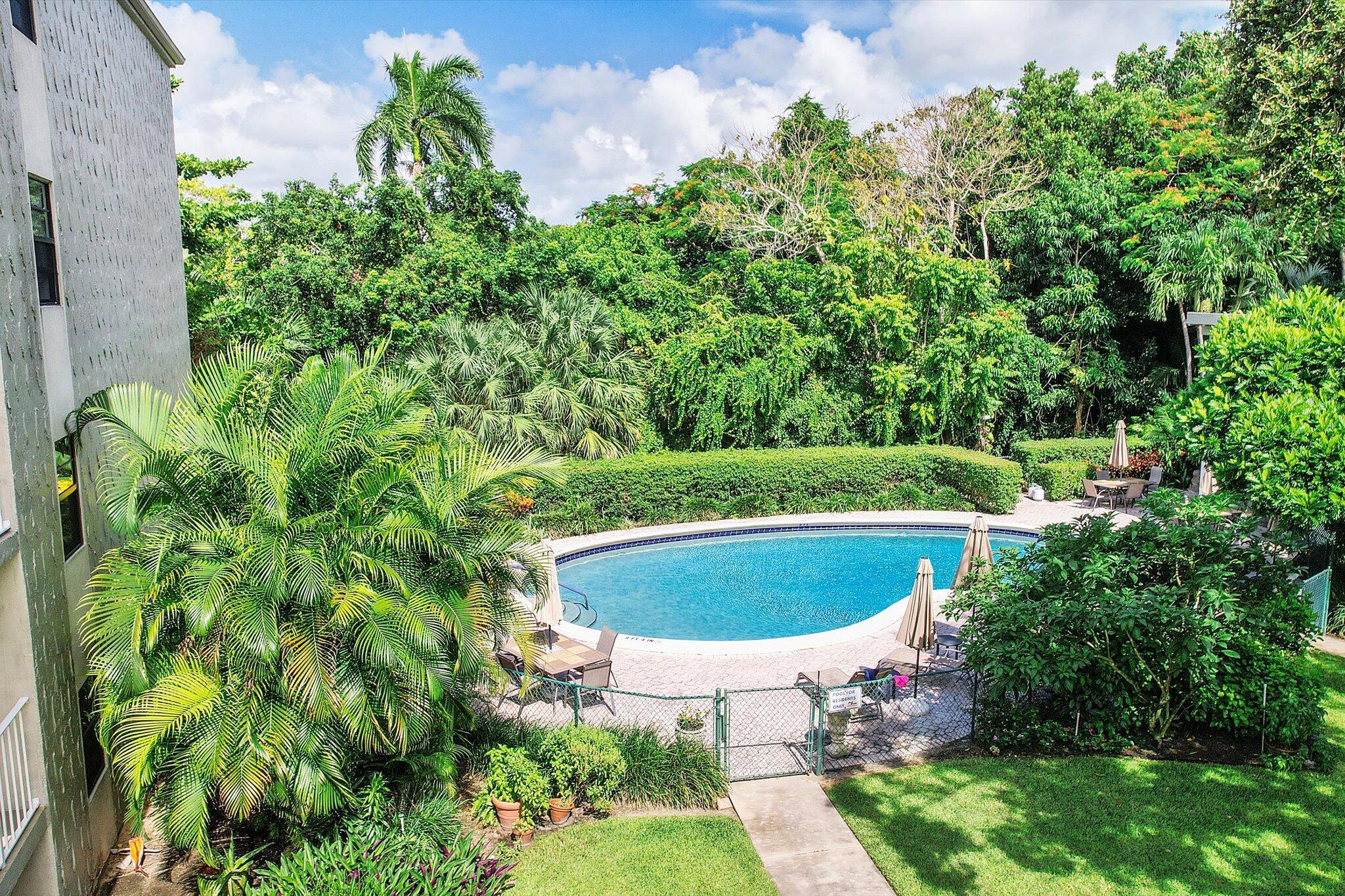 501 Southwest 11th Place, Unit 418 Boca Raton, FL 33432 - Photo 27 of 35 a view of a swimming pool with a yard