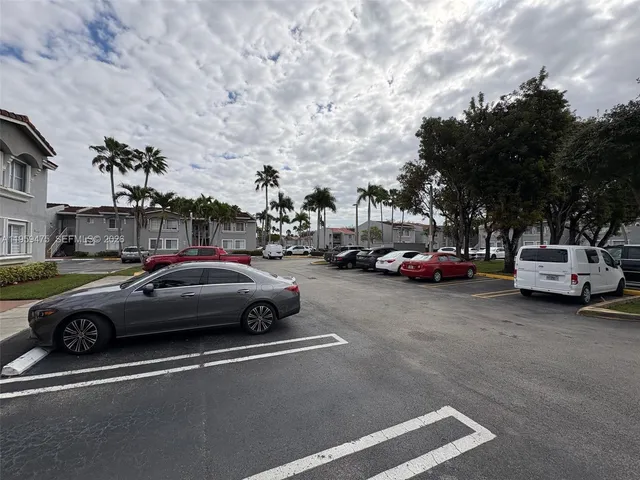 a front view of a building with palm trees