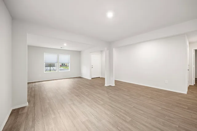 a view of an empty room and wooden floor