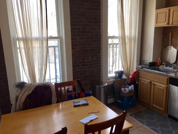 a view of a dining room with furniture and a window