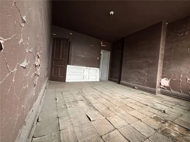 a view of a door and wooden floor
