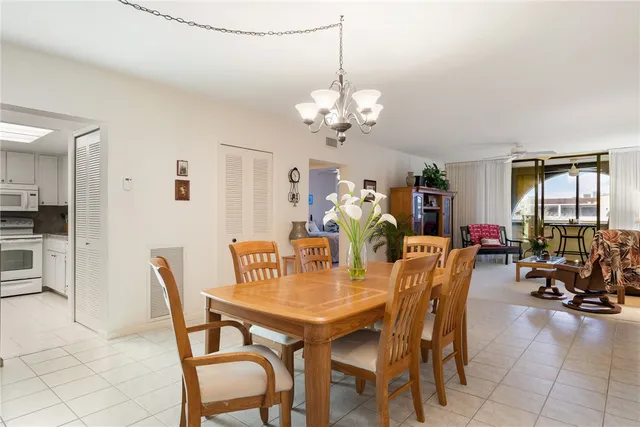 a view of a dining room with furniture and chandelier