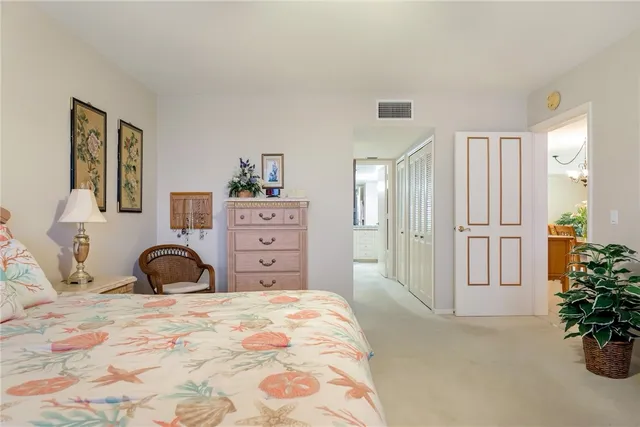 a bedroom with a bed and a potted plant