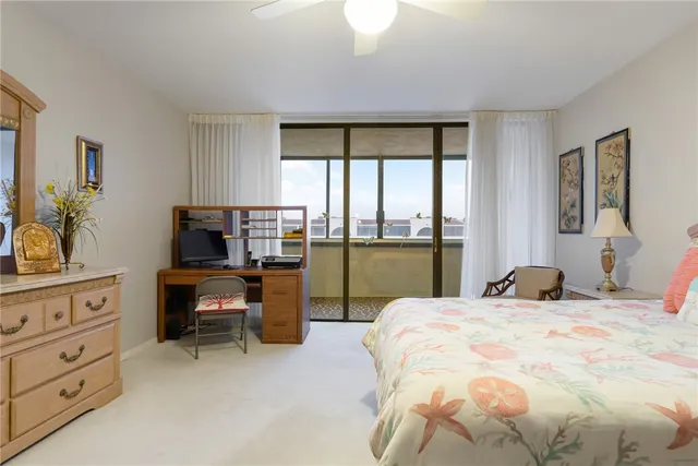 a bedroom with a bed and a large window