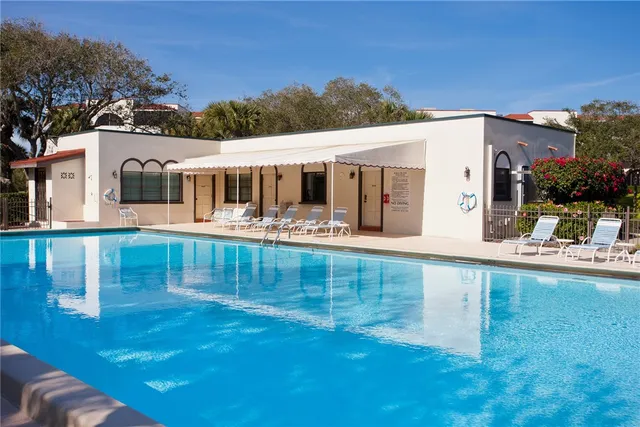 a view of a house with pool and a yard