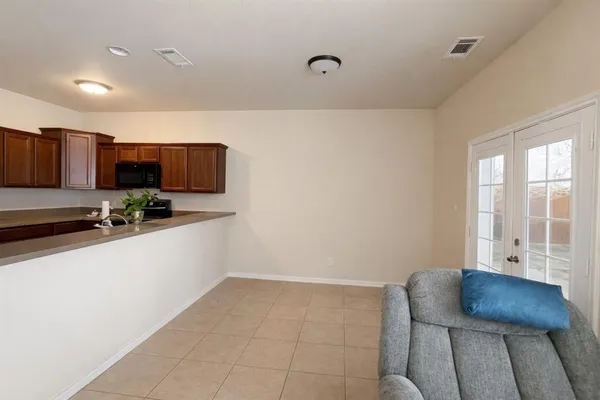 a kitchen with stainless steel appliances a stove a sink a microwave a refrigerator and cabinets