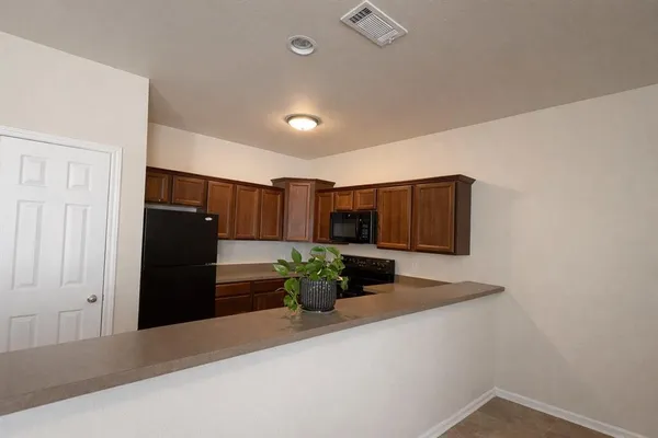 a view of an empty room with a window and a flat screen tv