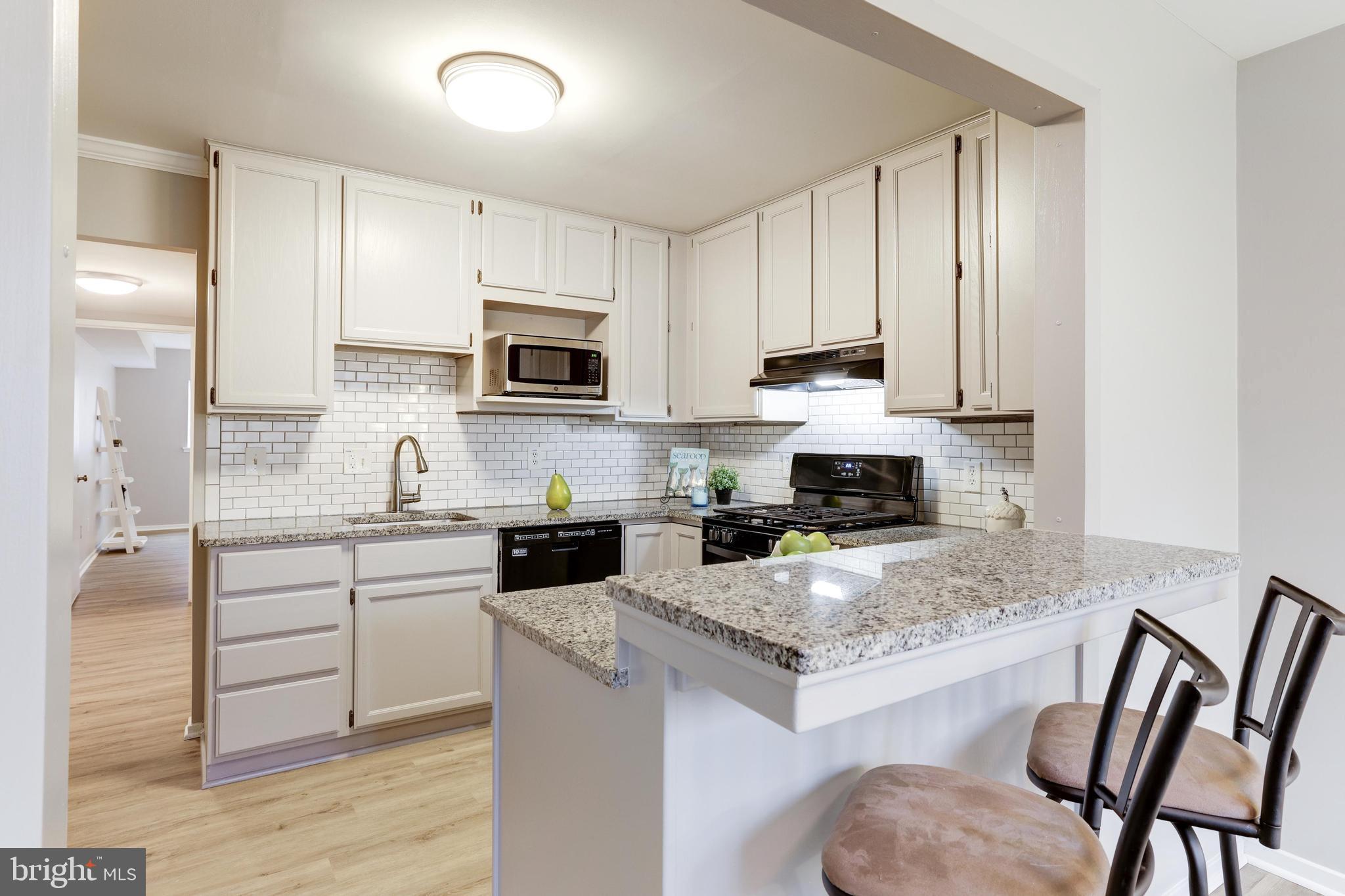 1668 Parkcrest Circle, Unit 100 Reston, VA 20190 - Photo 12 of 22 Renovated kitchen with subway tile backsplash.