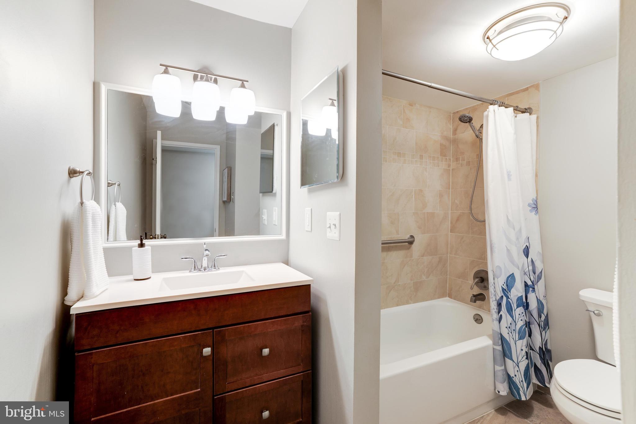 1668 Parkcrest Circle, Unit 100 Reston, VA 20190 - Photo 17 of 22 Bath with updated cabinet,flooring, counter, light