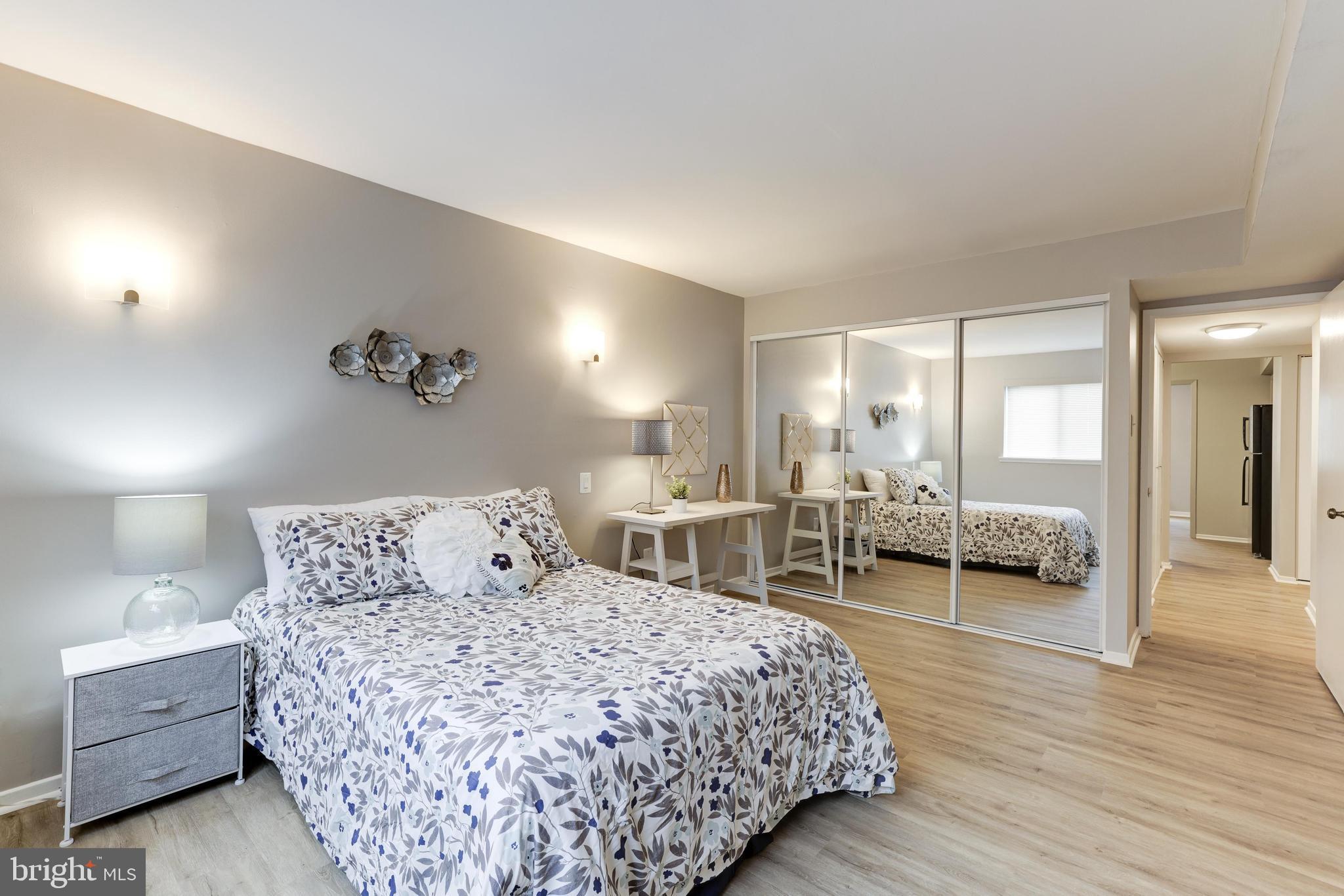 1668 Parkcrest Circle, Unit 100 Reston, VA 20190 - Photo 18 of 22 Large bedroom with wall reading sconces.