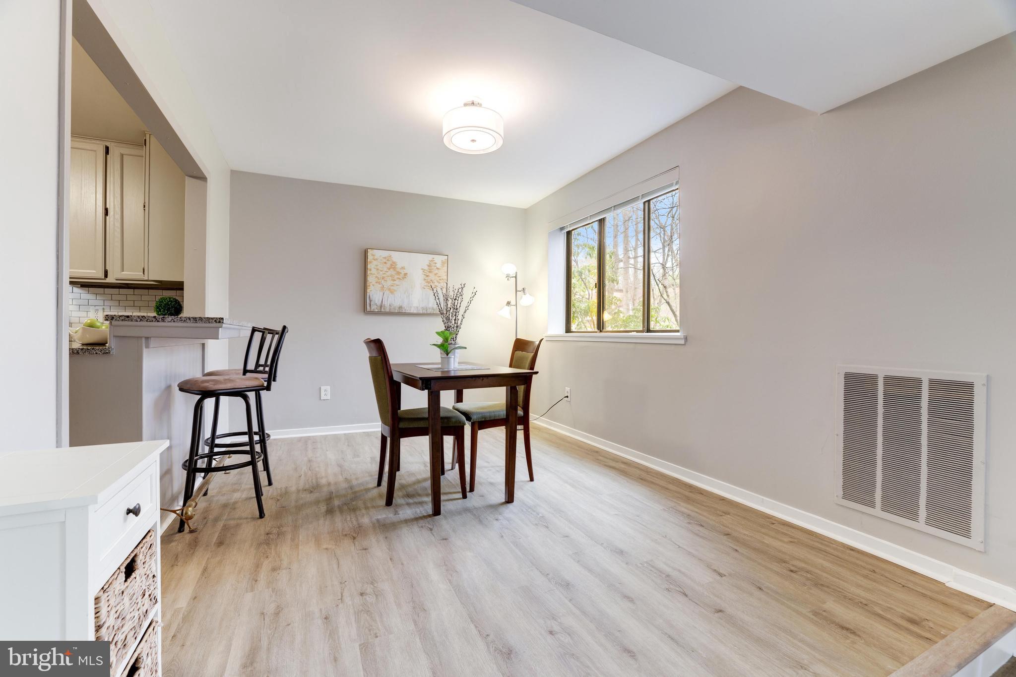 1668 Parkcrest Circle, Unit 100 Reston, VA 20190 - Photo 9 of 22 Large dining area is open to kitchen breakfast bar