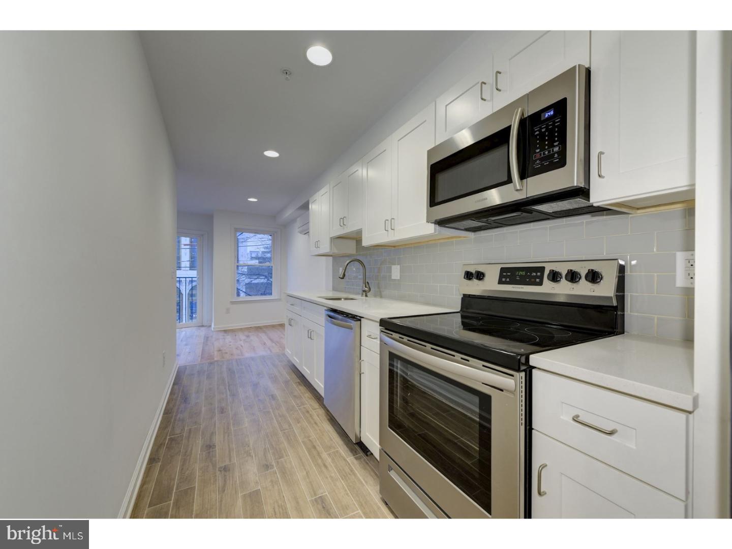 620 North 2nd Street Philadelphia, PA 19123 - Photo 3 of 7 a kitchen with stainless steel appliances a stove microwave and sink