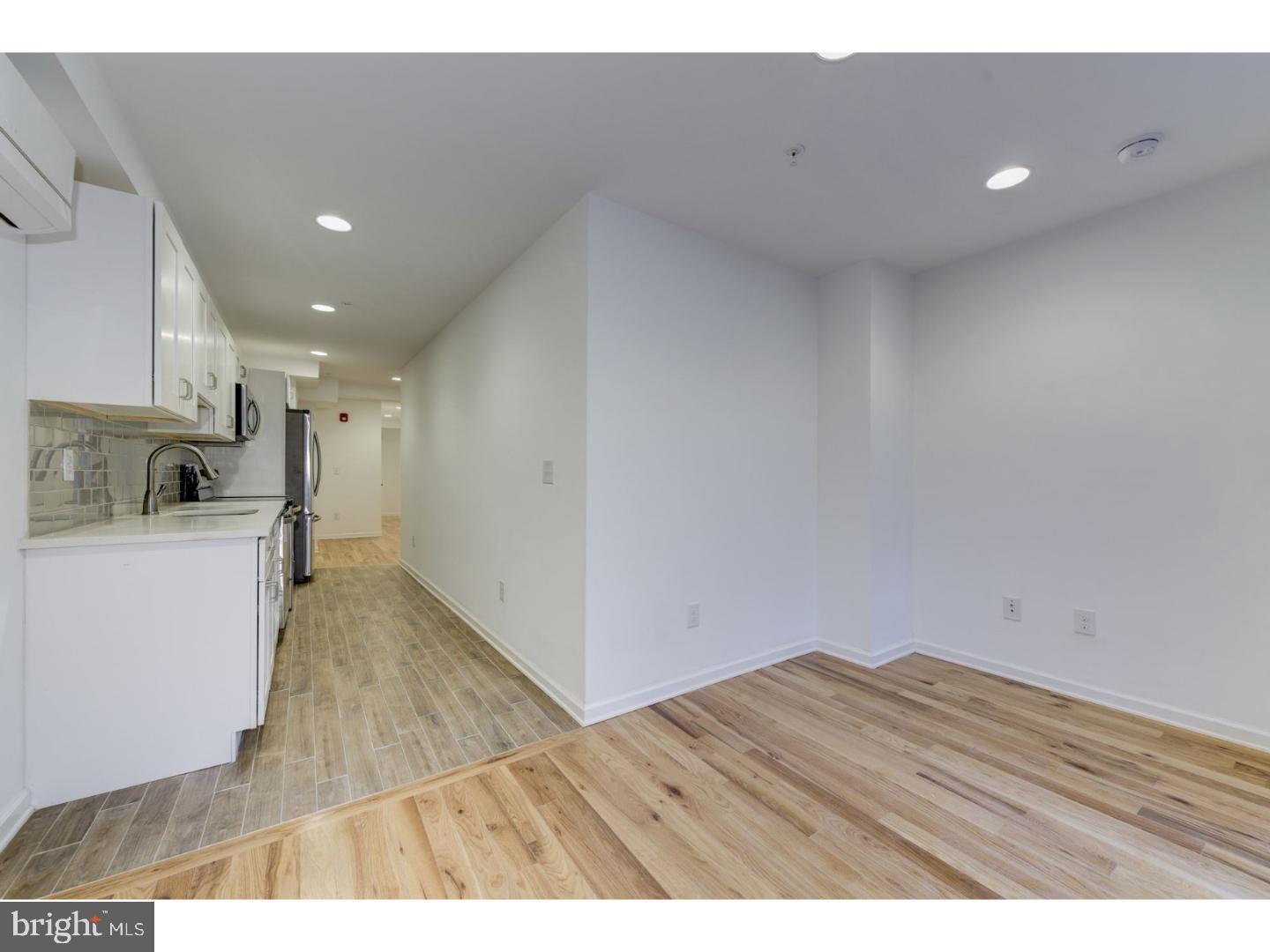 620 North 2nd Street Philadelphia, PA 19123 - Photo 4 of 7 a view of kitchen and empty room with wooden floor