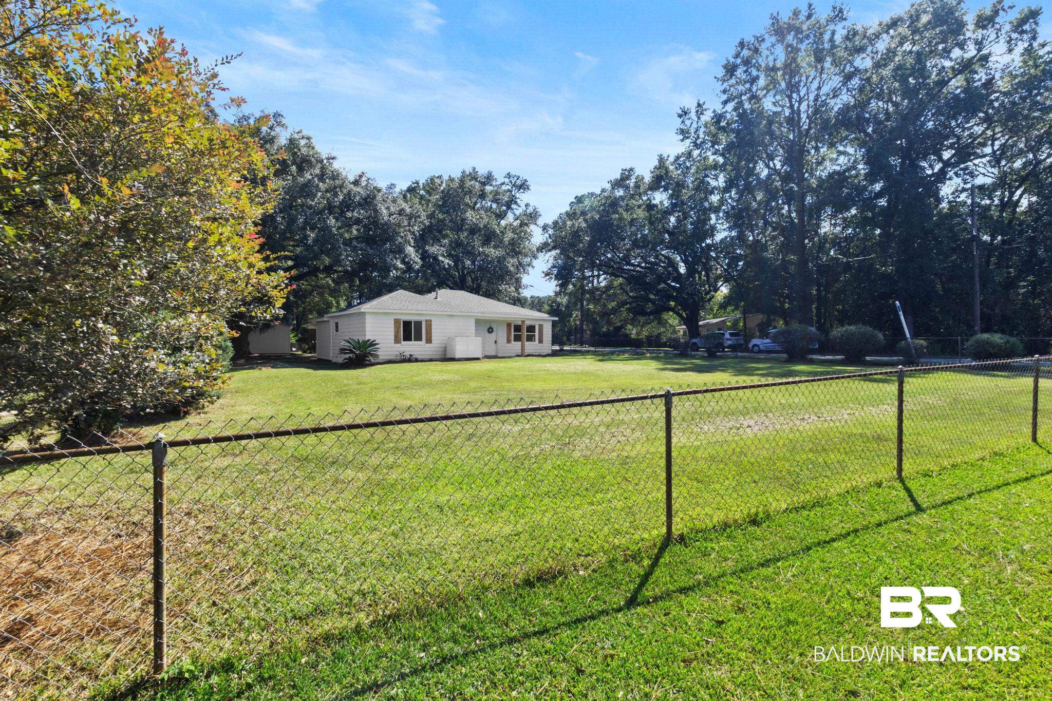 618 Pine Street Saraland, AL 36571 - Photo 23 of 41 Fenced backyard featuring view of scattered trees