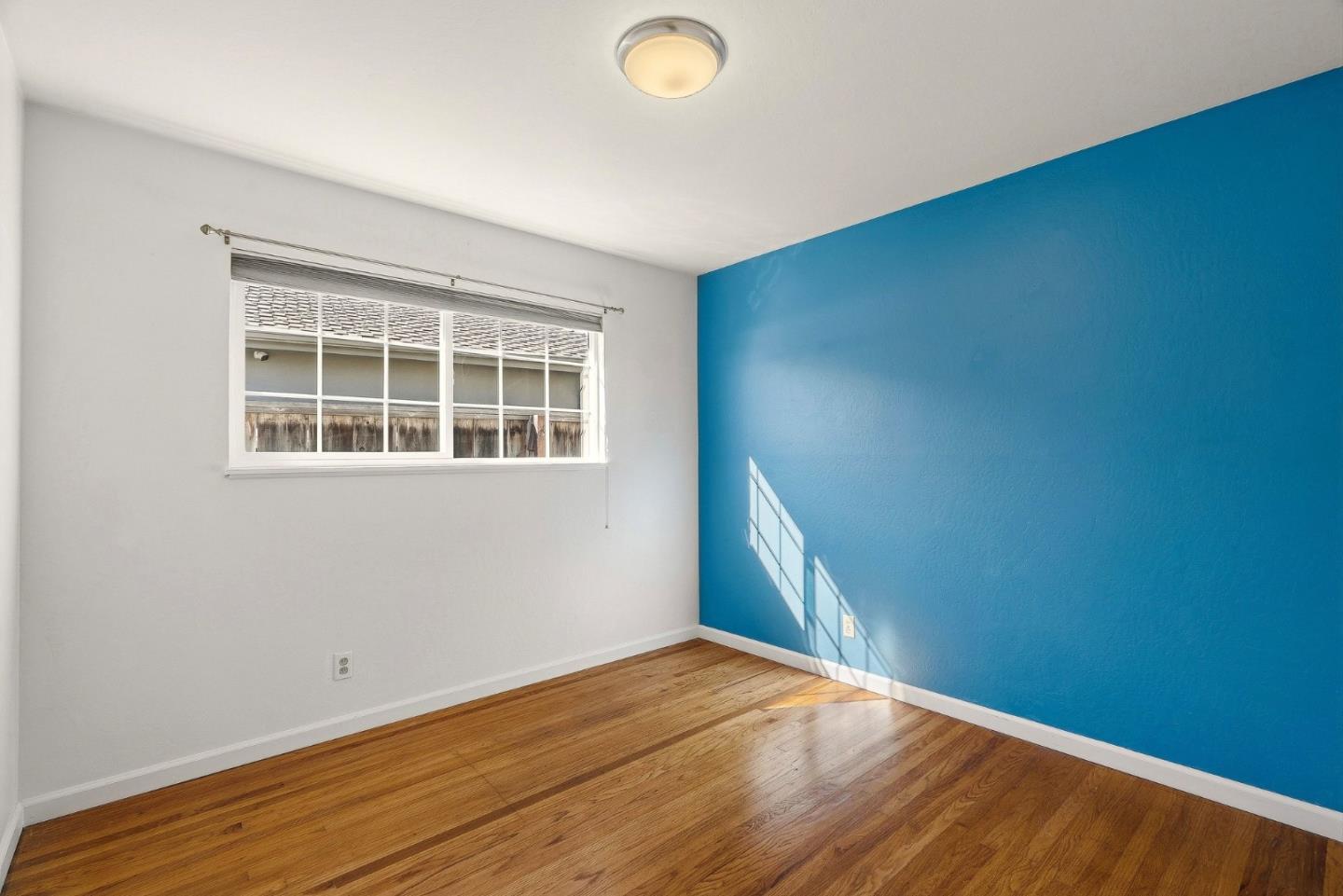 15 Del Rey Circle Salinas, CA 93901 - Photo 12 of 42 a view of empty room with wooden floor and fan