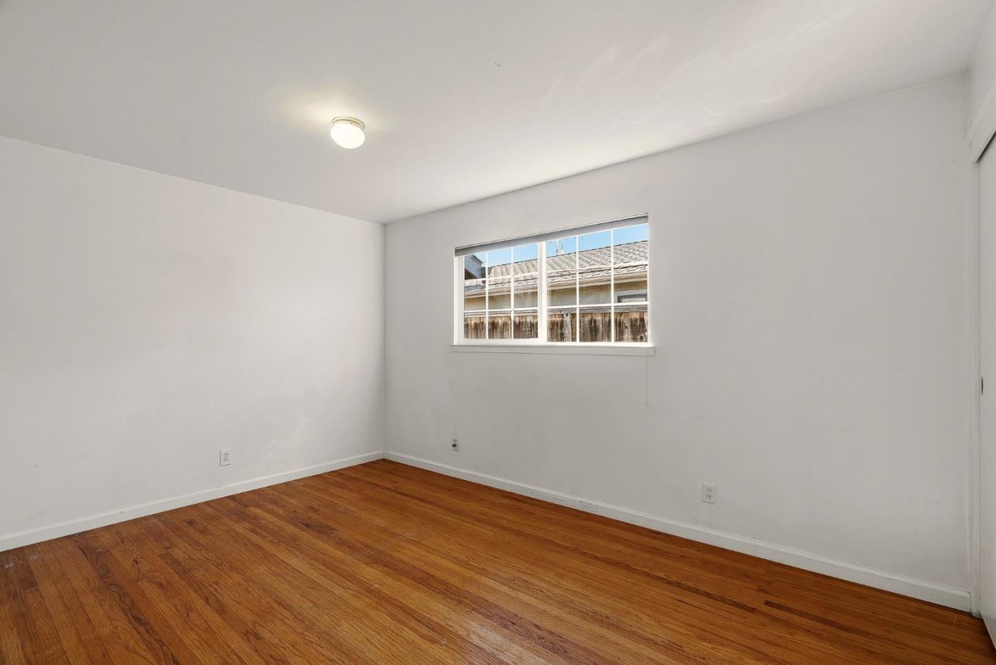 15 Del Rey Circle Salinas, CA 93901 - Photo 13 of 42 a view of empty room with wooden floor and fan