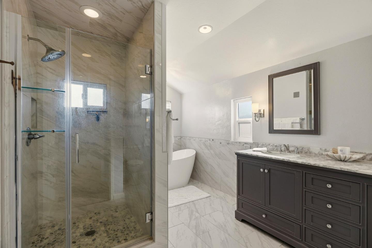 15 Del Rey Circle Salinas, CA 93901 - Photo 19 of 42 a bathroom with a granite countertop sink a toilet a mirror and shower