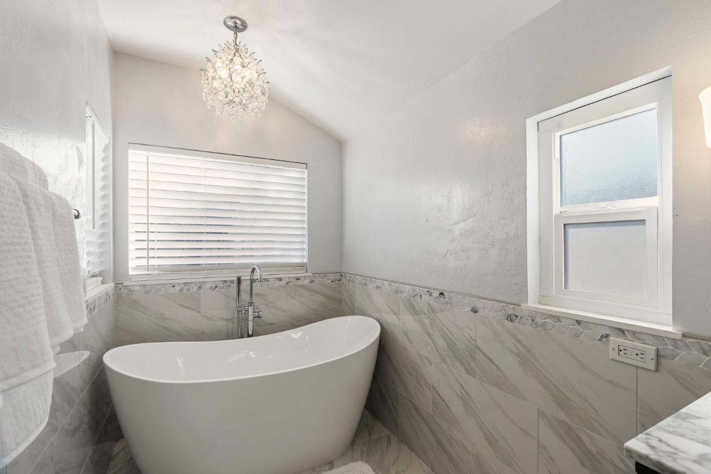 15 Del Rey Circle Salinas, CA 93901 - Photo 21 of 42 a white bath tub sitting in a bathroom next to a window
