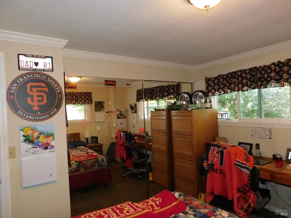a living room with furniture a flat screen tv and a large window