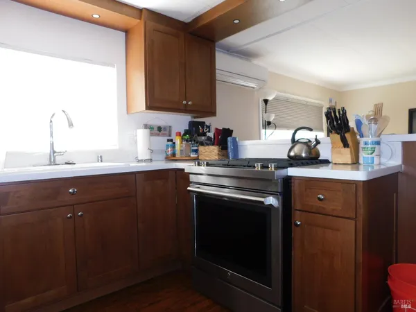 a kitchen with stainless steel appliances granite countertop a sink stove and cabinets