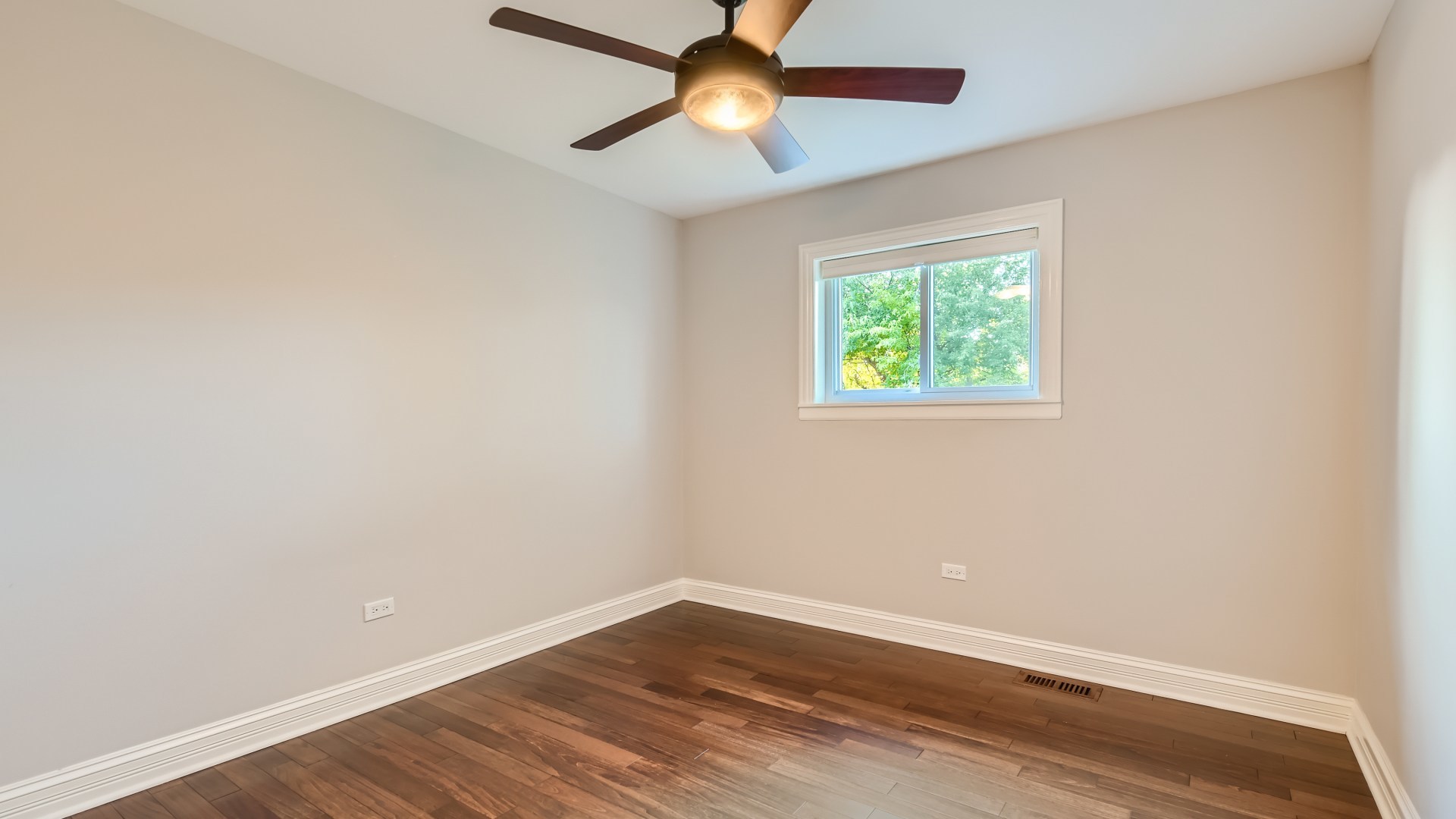 177 South Pinecrest Road Bolingbrook, IL 60440 - Photo 14 of 25 an empty room with wooden floor chandelier fan and windows