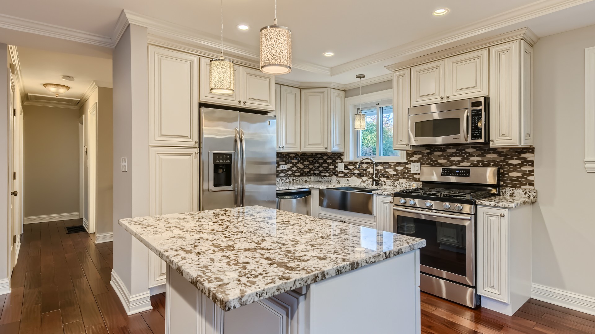 177 South Pinecrest Road Bolingbrook, IL 60440 - Photo 6 of 25 a kitchen with stainless steel appliances kitchen island granite countertop a stove refrigerator and microwave