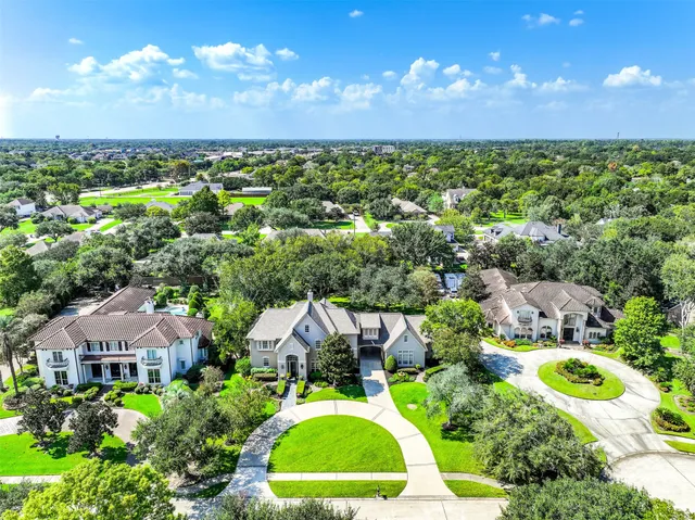 an aerial view of residential houses with outdoor space and street view