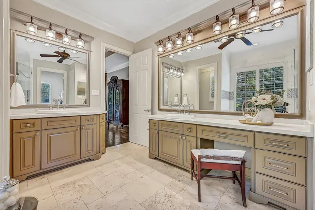a spacious en suite bathroom with a granite countertop sink a toilet and a mirror