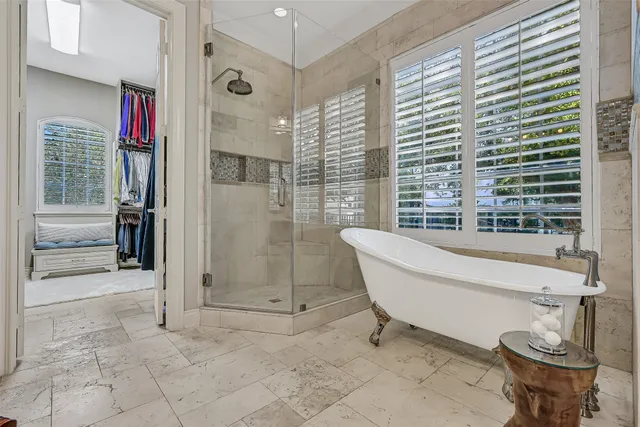 a bathroom with a bathtub and a shower