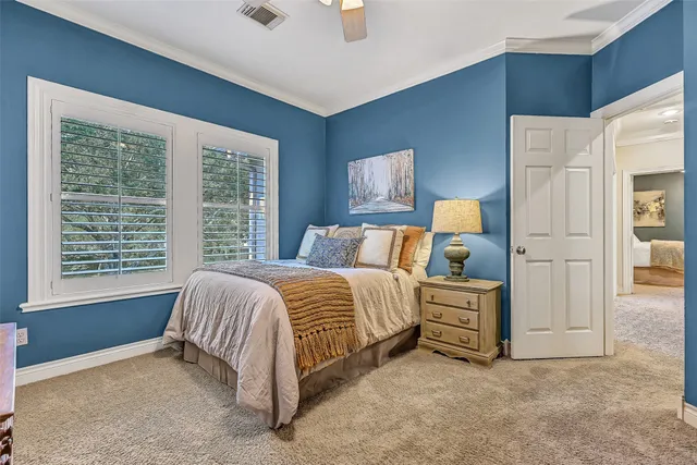 a spacious bedroom with a bed and a cabinets