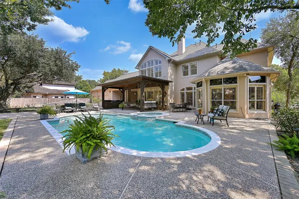 a view of a backyard with sitting area