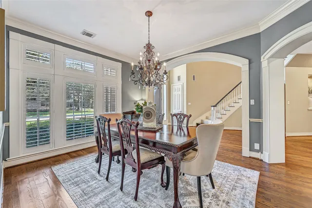 a view of a dining room with furniture wooden floor and chandelier