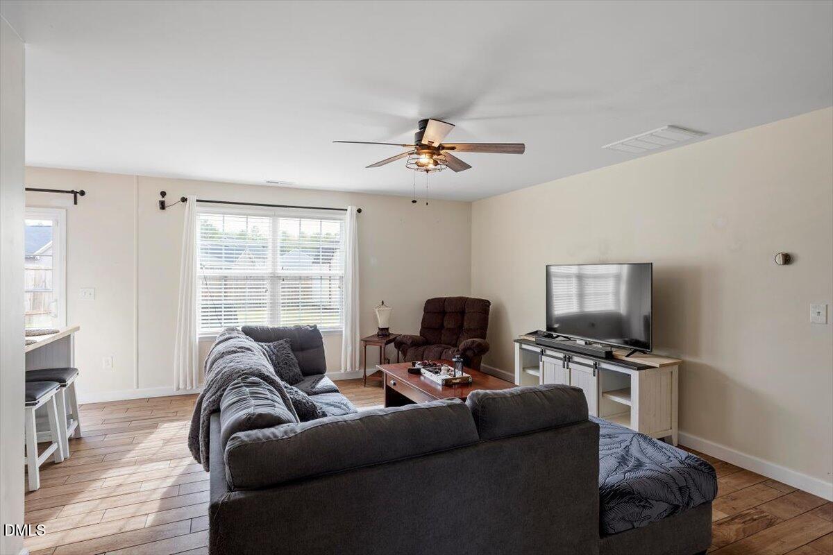 205 Battery Way Bunnlevel, NC 28323 - Photo 7 of 37 a living room with furniture a flat screen tv and a fireplace