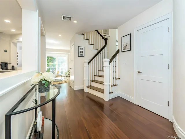 a view of an entryway with wooden floor and stairs