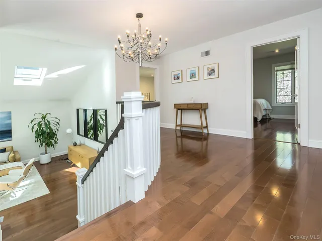 a view of entryway and hall with wooden floor