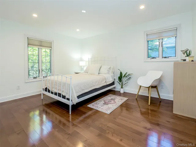 a bed room with a bed and a chair