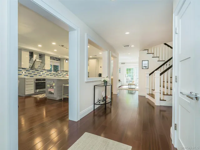 a open kitchen with white cabinets and stainless steel appliances
