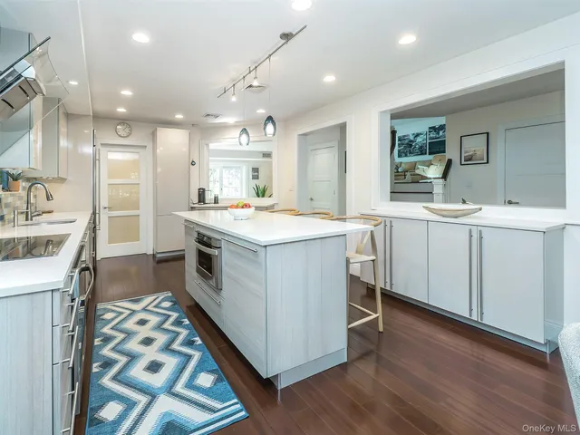 a kitchen with a sink stove and wooden cabinets
