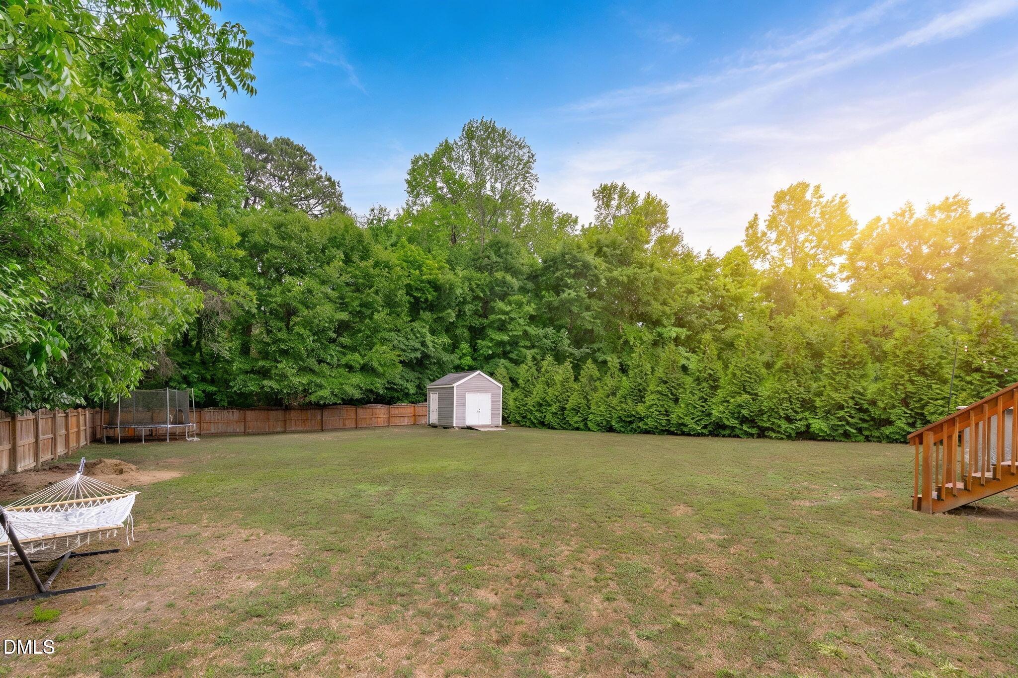 2450 Rolling Tracks Road Willow Spring, NC 27592 - Photo 6 of 64 a view of a lake with a yard