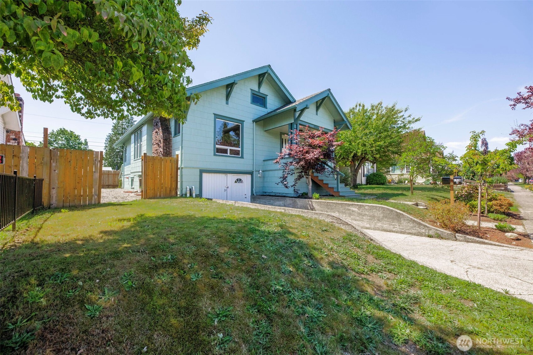 a front view of house with yard and trees around