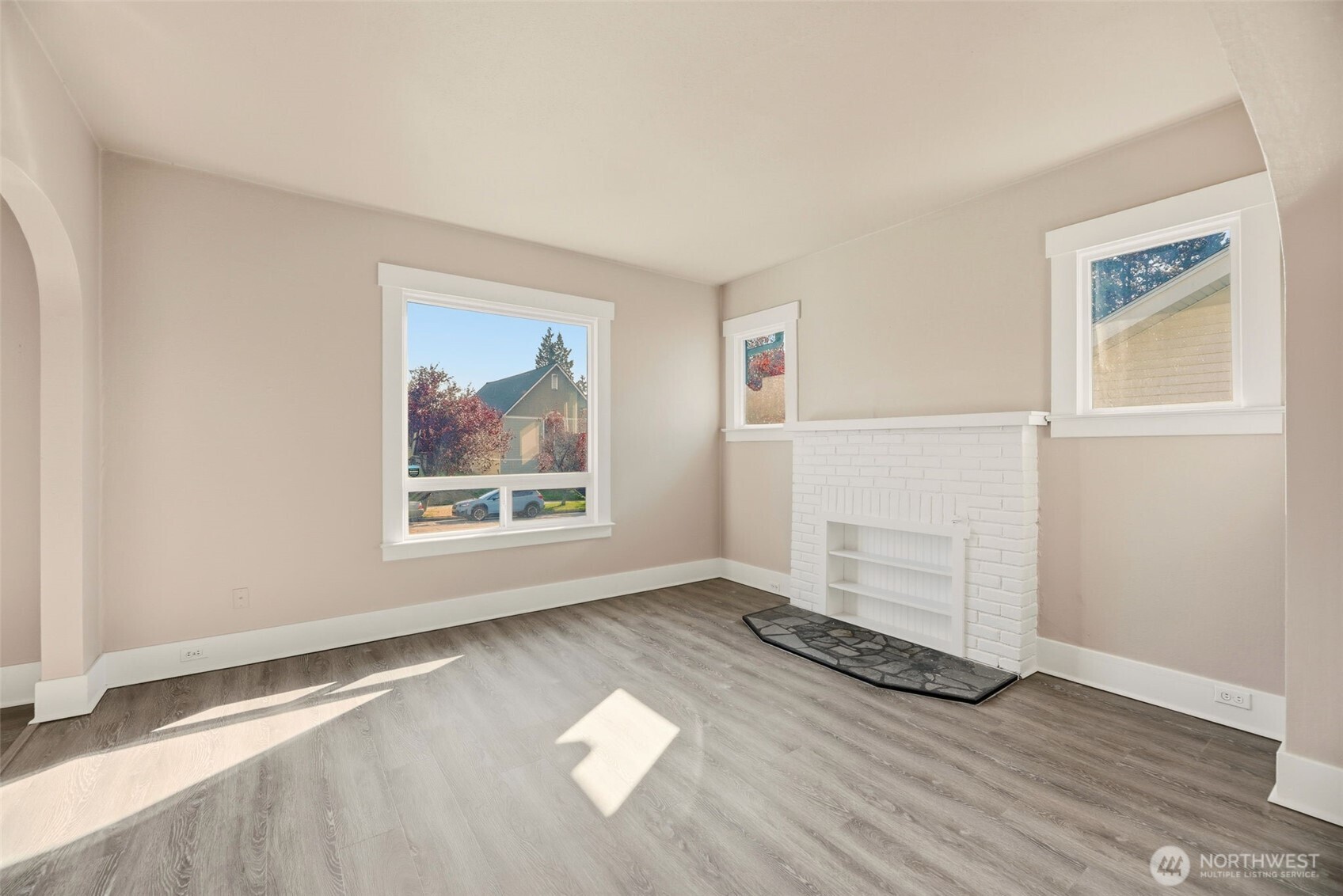 1726 Baker Avenue Everett, WA 98201 - Photo 12 of 39 an empty room with wooden floor and windows